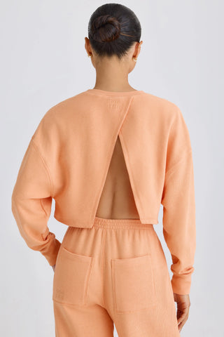 Textured Cotton Jersey Open-Back Cropped Sweatshirt in Peach